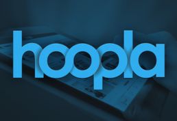 background image of tablet with the hoopla app and titles to checkout with text in foreground: hoopla.
