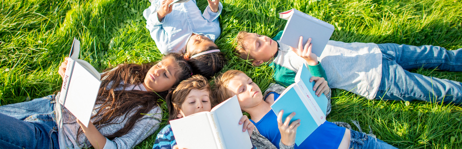 kids reading in the grass