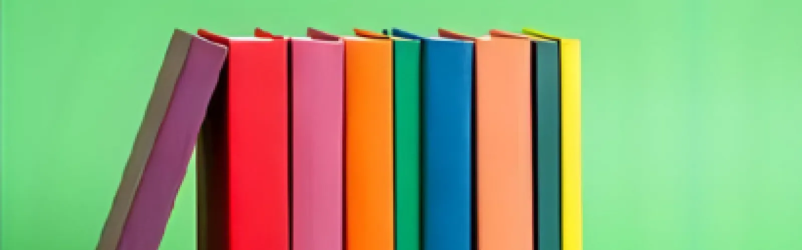 colorful book spines on a solid green background